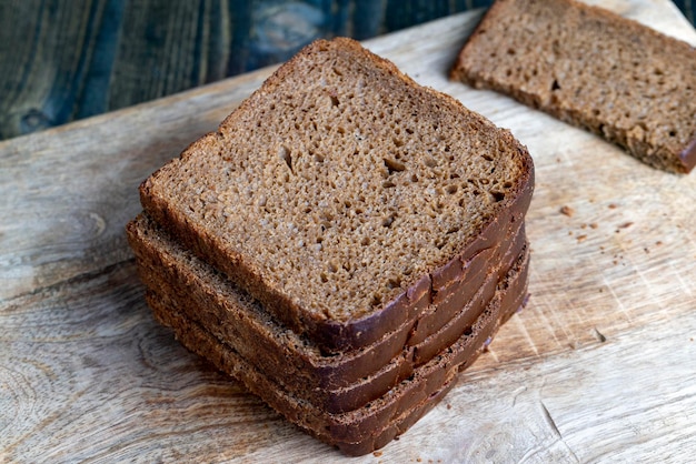 Sliced rye bread on a wooden table close up