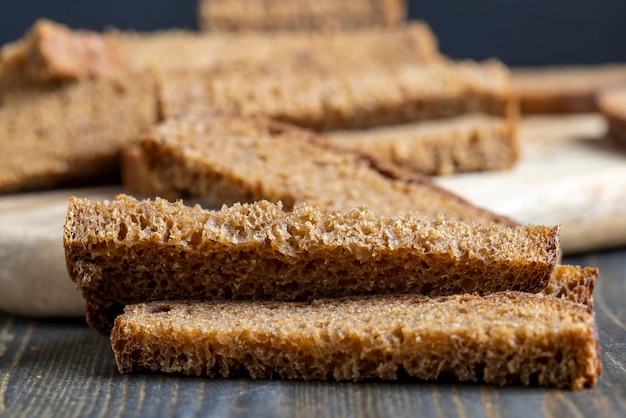 Sliced rye bread on a wooden table close up