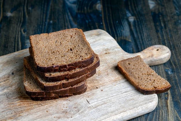 Sliced rye bread on a wooden table close up