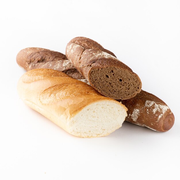 Sliced rye and wheat baguettes on a white background