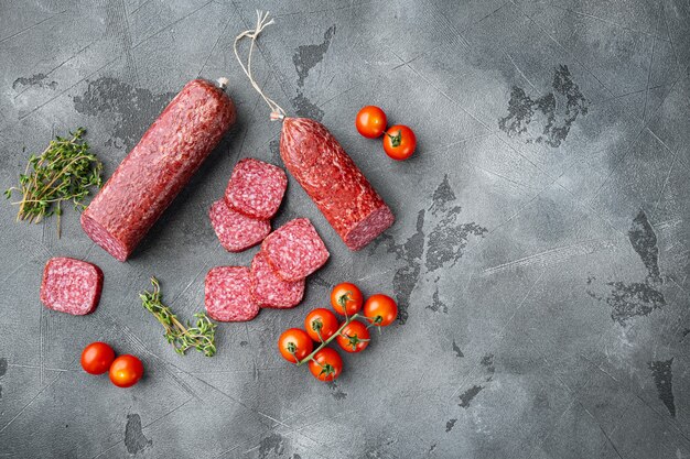 Sliced salami set, on gray stone table, top view flat lay