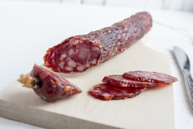 Photo sliced salami on white