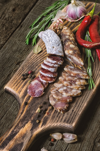 Sliced salami with rosemary and chili pepper.