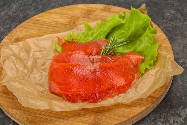 Sliced salmon fillet served rosemary