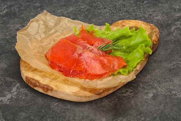 Sliced salmon fillet served rosemary