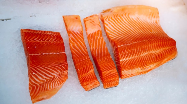 Sliced salmon lying on the ice in the refrigerator store