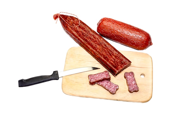 Sliced sausage two varieties on a wooden kitchen plaque on a white background