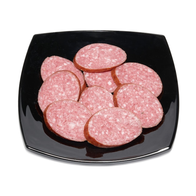 Photo sliced sausage with black plate isolated on white