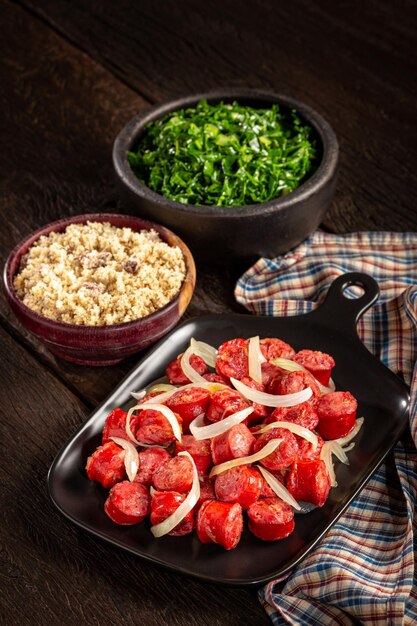 Sliced sausage with onion green cabbage and farofa