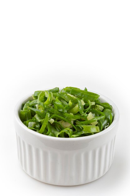 Sliced scallion in ramekin isolated on white background