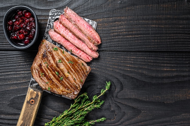 Sliced skirt beef meat steak on a cleaver