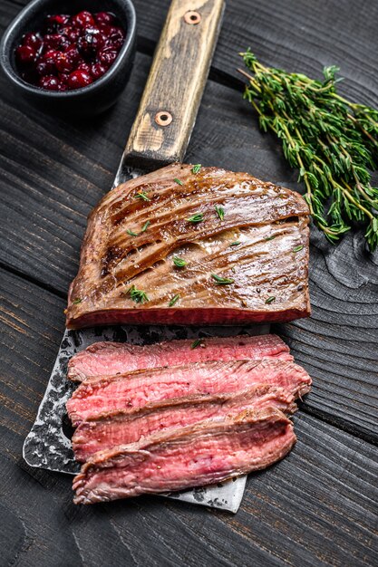 Sliced skirt beef meat steak on a cleaver