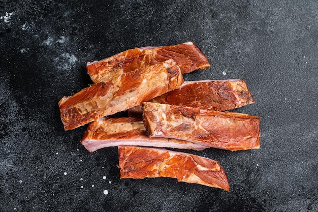 Sliced Smoked BBQ Pork Ribs Black background Top view