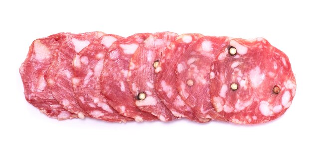 Sliced smoked dry salami sausage isolated on white background