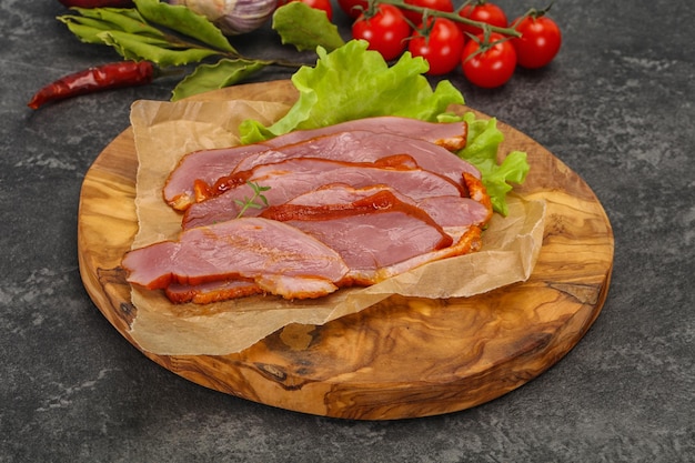 Sliced smoked duck breast served salad