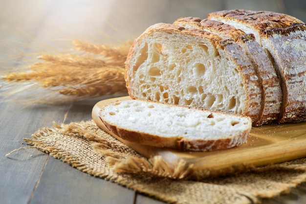 Sliced Sourdough Bread on wood board on wood background homemade bakery