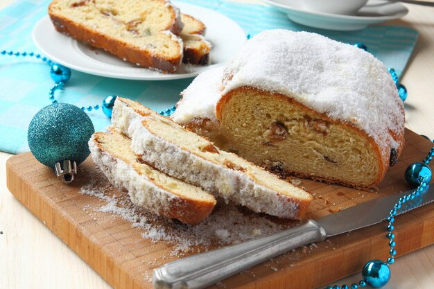 Sliced stollen with christmas decoration, a traditional German fruit cake