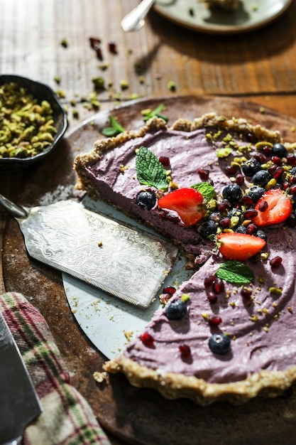 Sliced sweet potato tart topped with strawberries and blueberries