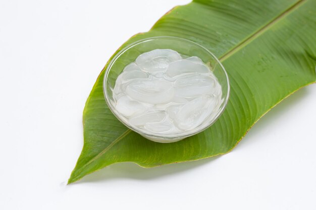 Sliced toddy palm in syrup in glass bowl on green leaf