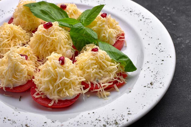 Sliced tomatoes with cheese and mayonnaise on a plate