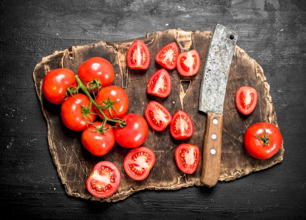 Sliced tomatoes on a wooden cutting Board.