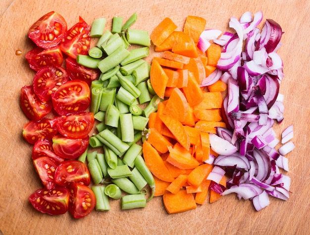 Photo sliced of vegetables tomato asparagus cucumber onions