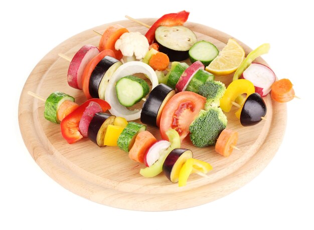 Sliced vegetables on wooden picks isolated on white