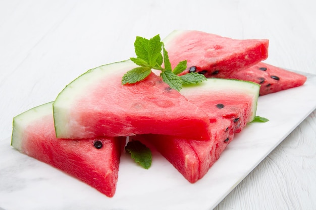 Sliced watermelon on white marble background