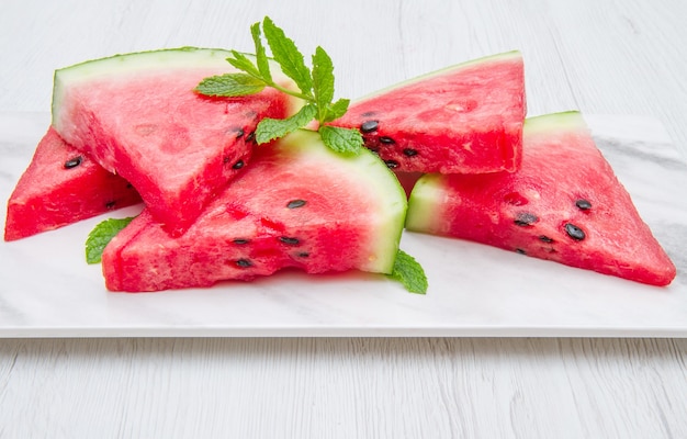 Sliced watermelon on white marble surface