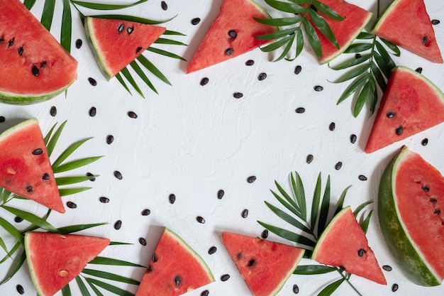 Sliced watermelon with palm tree on white background