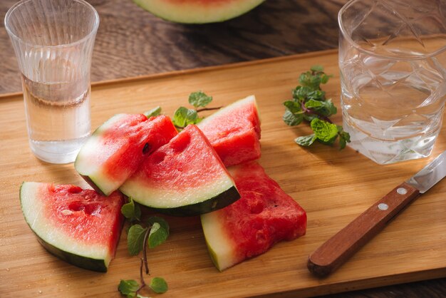 Sliced watermelon with pure water on the wood backgroud