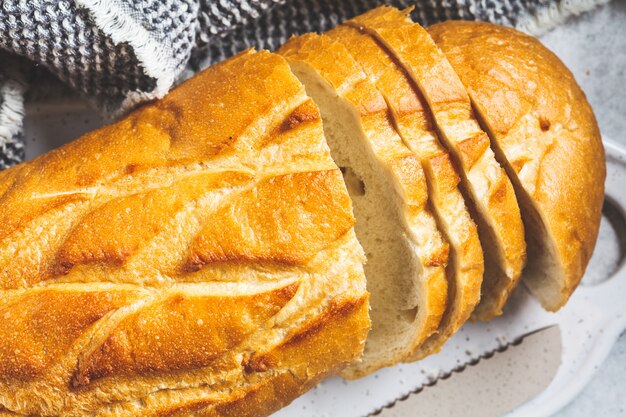 Sliced wheat bread on the white board.