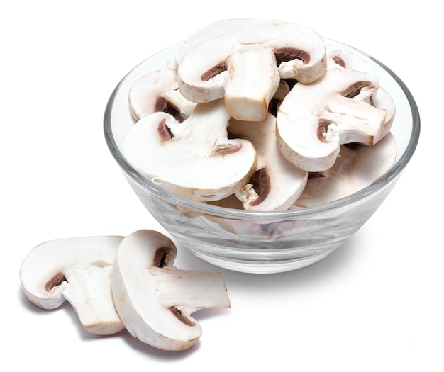 Sliced white champignon mushrooms in glass bowl isolated on white background