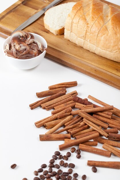 Sliced white loaf with spices on a white kitchen table