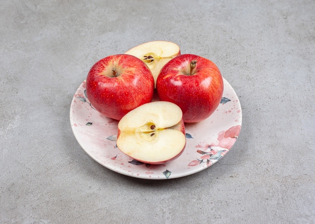 Sliced or whole apple on plate. Close up photos of fresh apples.