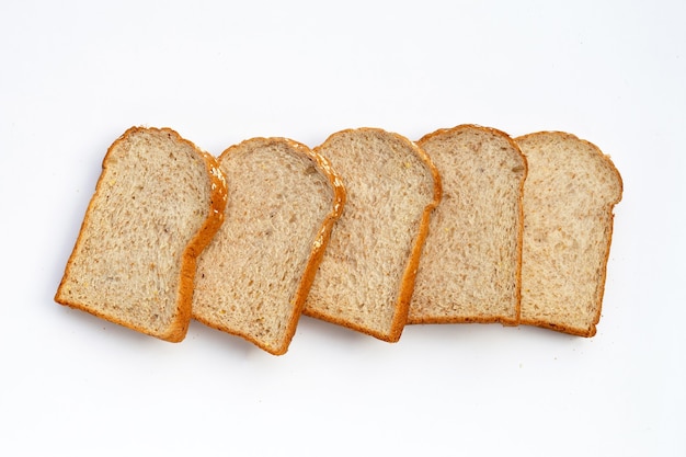 Sliced whole wheat bread on white surface