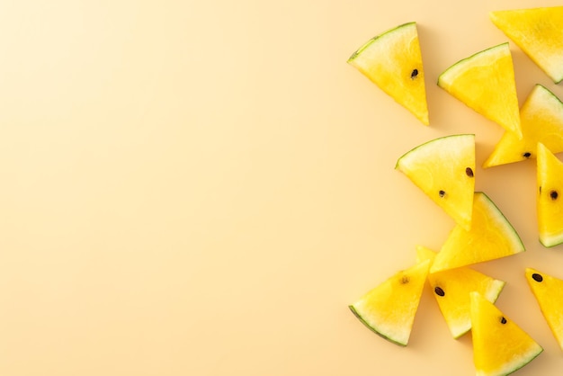 Sliced yellow watermelon pattern flat lay on pastel yellow table background
