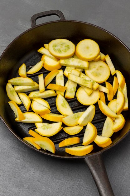 Sliced yellow zucchini in a frying pan