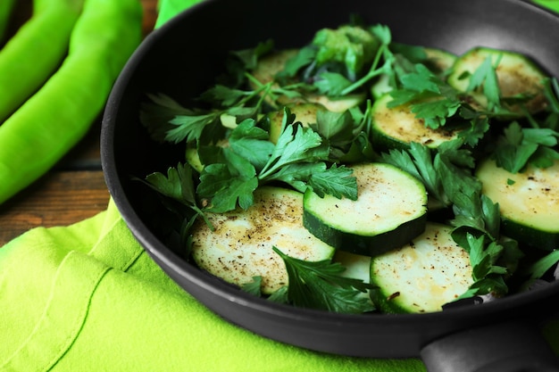 Sliced zucchini in pan on table closeup