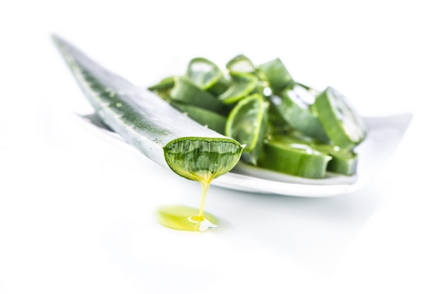 Slices of aloe vera with gel on white background.