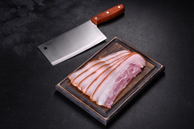 Slices of bacon on a wooden cutting Board Pork meat