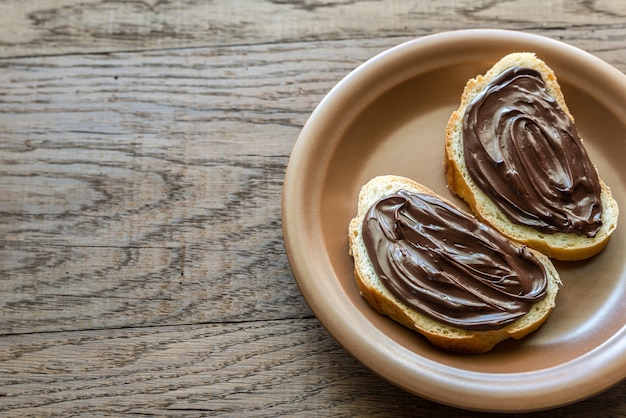 Slices of baguette with chocolate cream