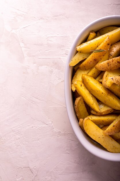 Slices of baked potatoes with rosemary and oil