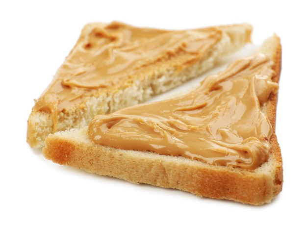 Slices of bread with creamy peanut butter isolated on white