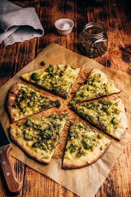 Slices of broccoli and cheese pizza