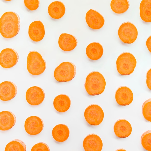 Photo slices of carrots on white background