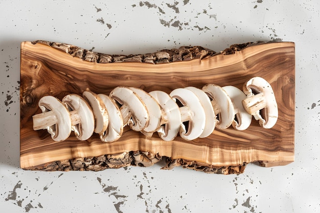 Slices of champignon mushrooms displayed on a rustic wooden kitchen board