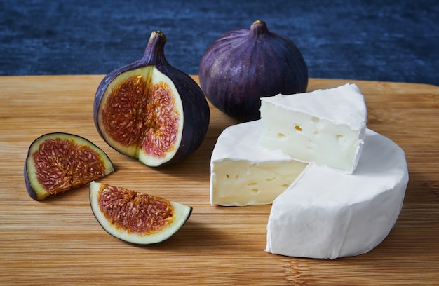 Slices of cheese Bree and figs, close up