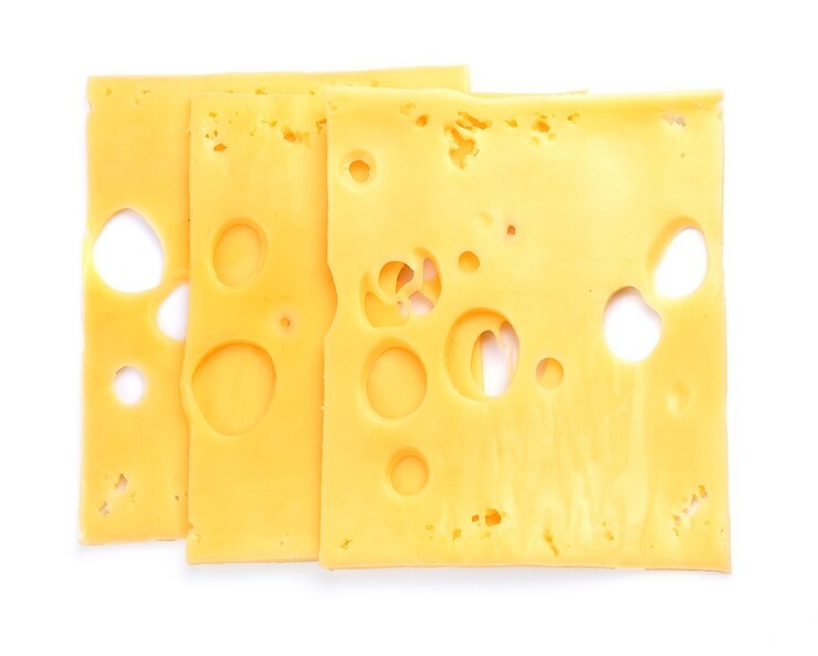 Slices of cheese isolated on white close up. 