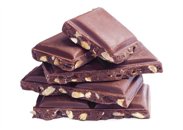 Slices of chocolate with nuts on a white background